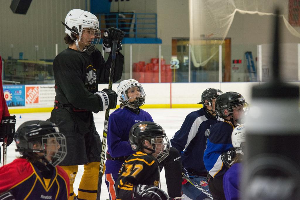 Youth Hockey Players listening to instruction from a coach during a hockey camp at the Ice Factory