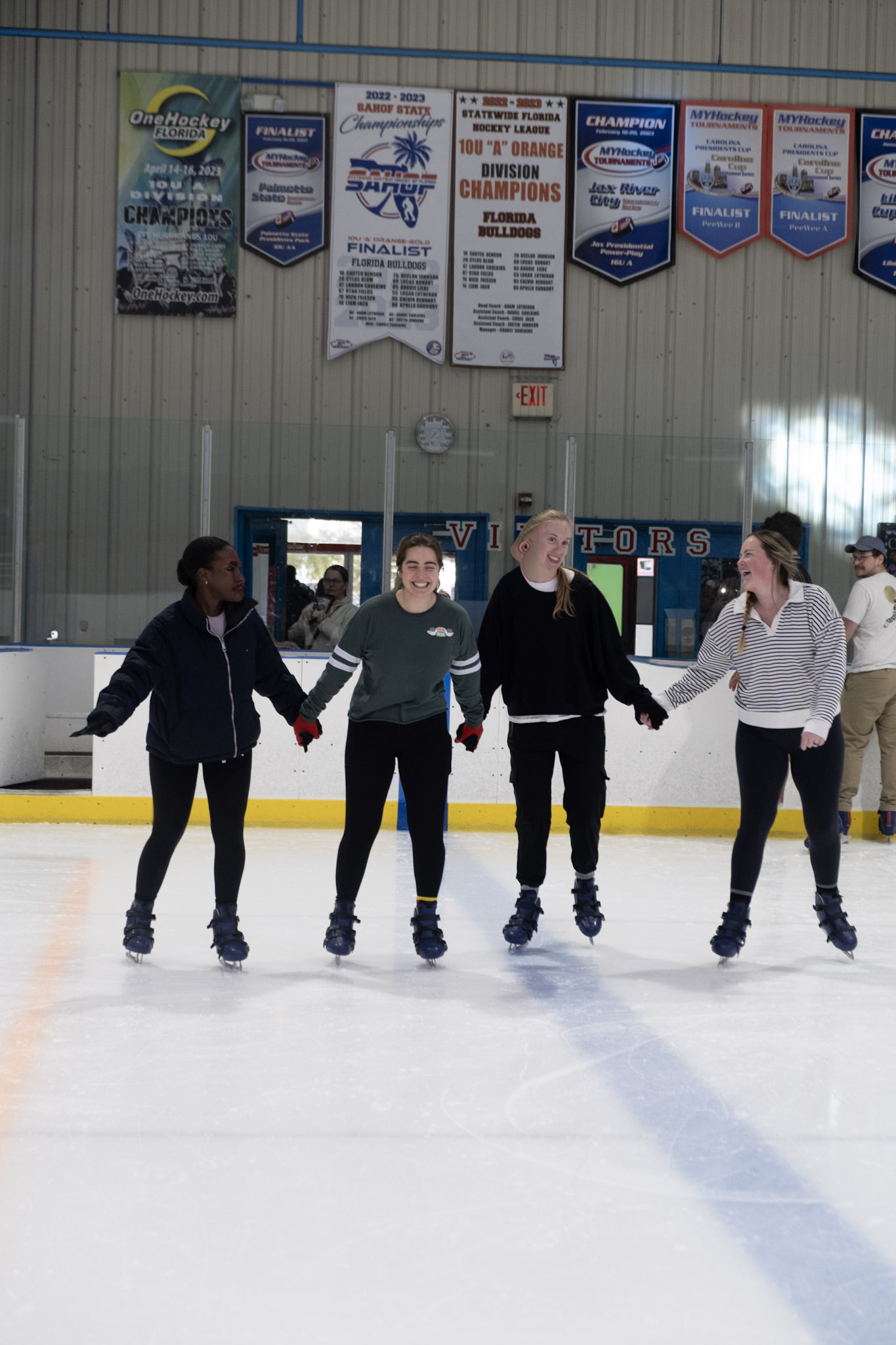 Group of girls ice skating at a public skating session at the Ice Factory