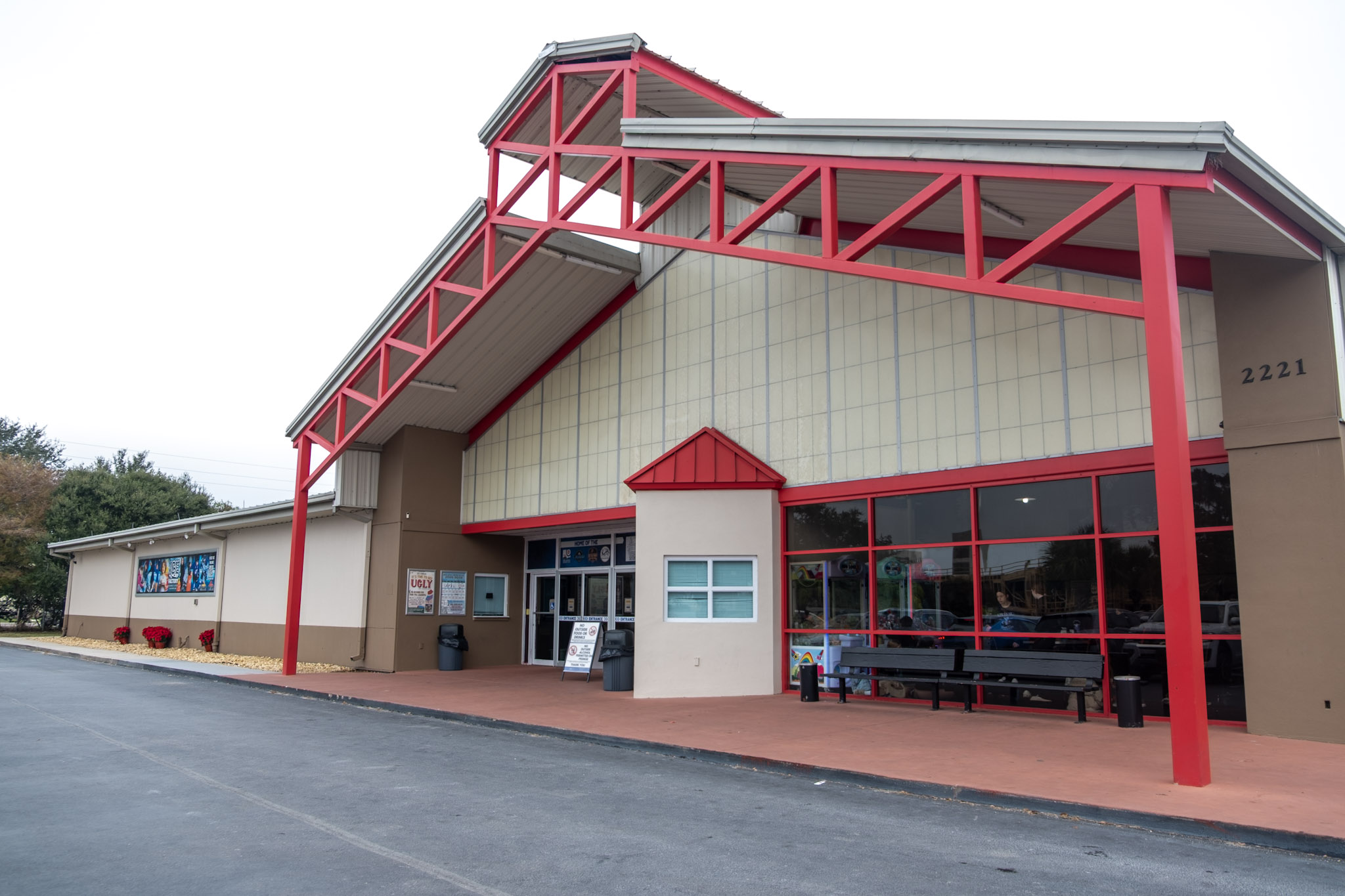Front entrance of the building a the ice factory, showcasing the red beam entrance and walk way.