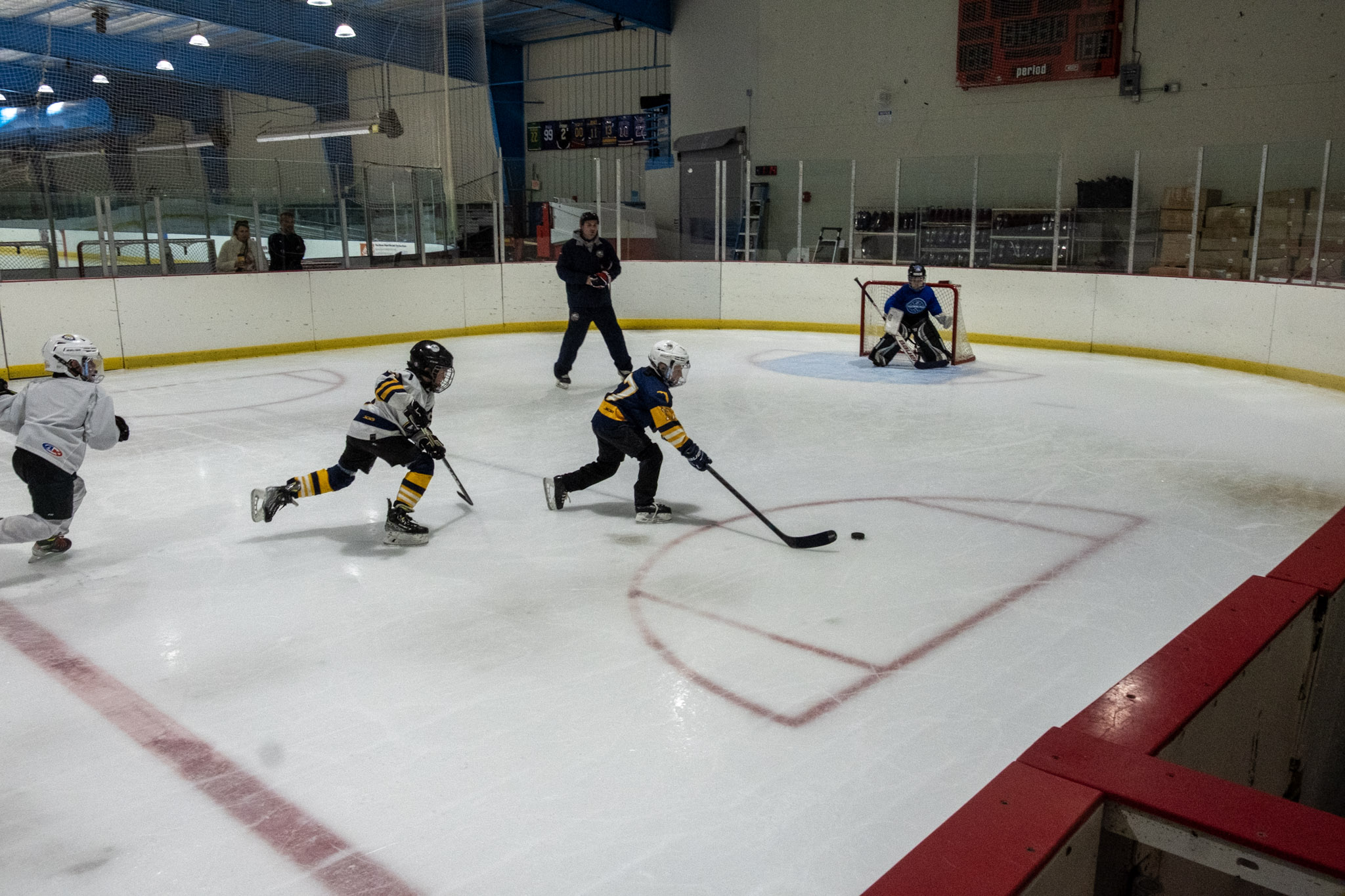 Youth hockey players playing a game of ice hockey on the studio rink at the ice factory