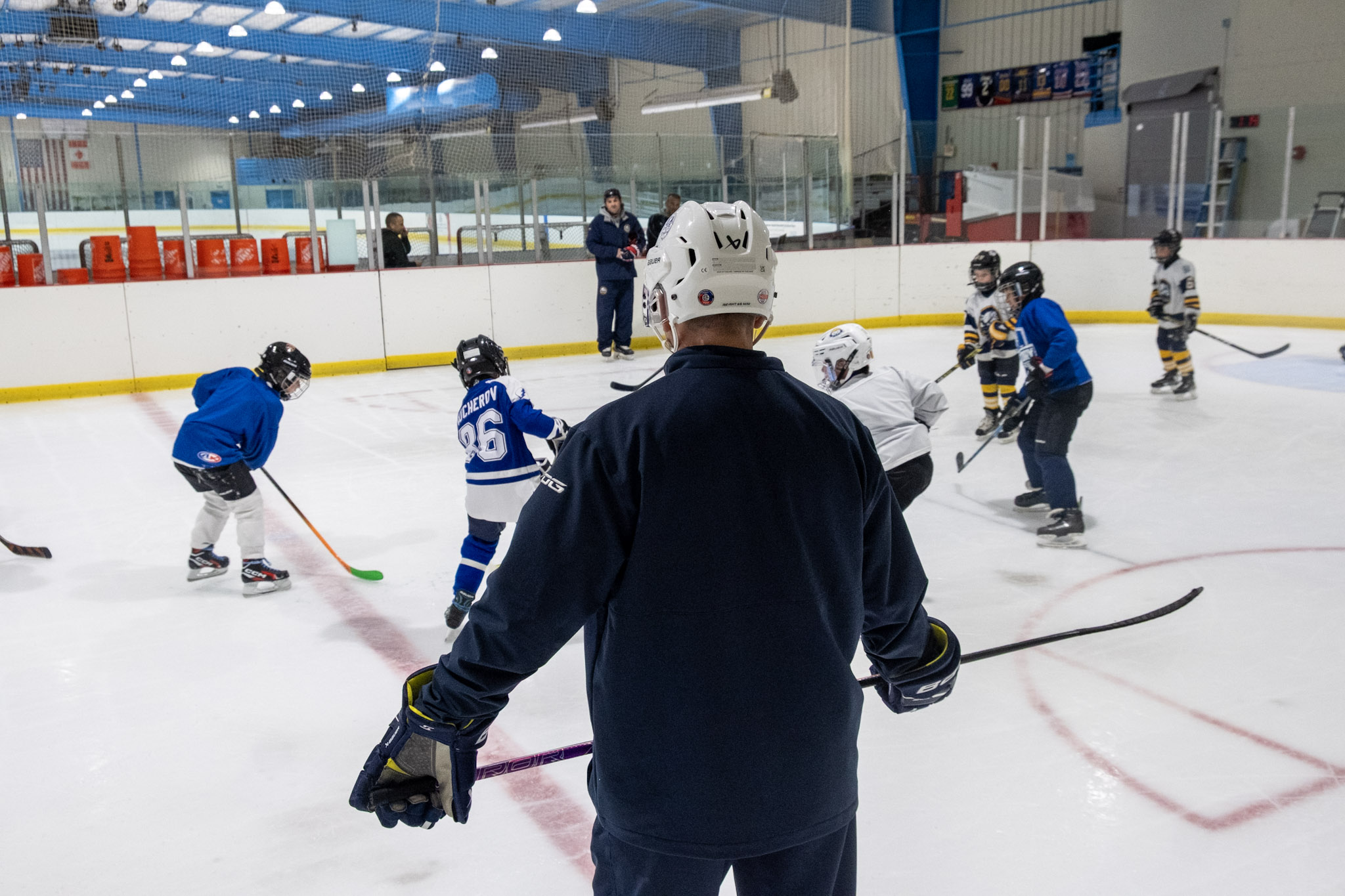 A usa hockey certified coach overseeing a practice on the studio rink at the Ice Factory